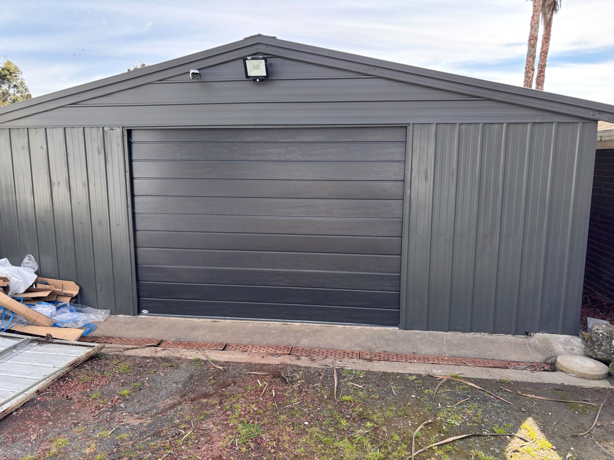 Grey sectional garage door on a metal garage